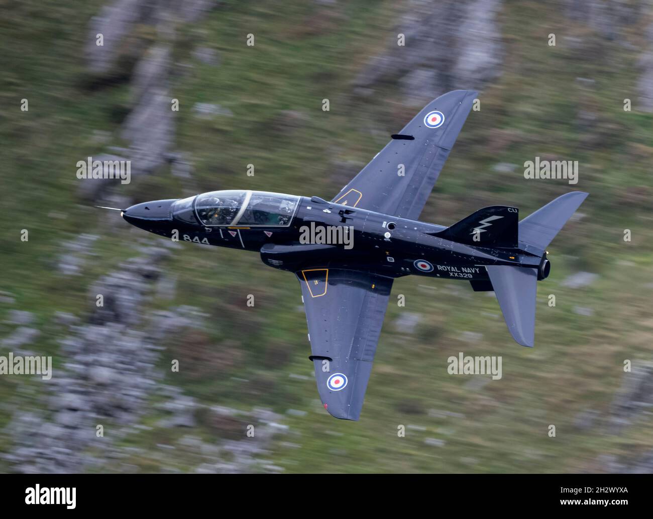 736 Squadron Royal Navy Hawk T1 aircraft flying low level in the Mach Loop, one of the jets XX200 was on a final flight to RAF Valley for retirement Stock Photo