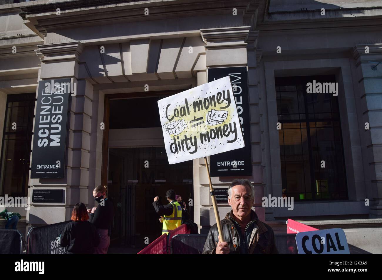 London, UK. 24th Oct, 2021. An activist holds a 'Coal Money = Dirty Money' placard during the protest outside the Science Museum. Extinction Rebellion activists gathered outside the museum in South Kensington in protest against the museum's 'greenwash' sponsorship by fossil fuel companies including Shell and coal giants Adani. (Photo by Vuk Valcic/SOPA Images/Sipa USA) Credit: Sipa USA/Alamy Live News Stock Photo