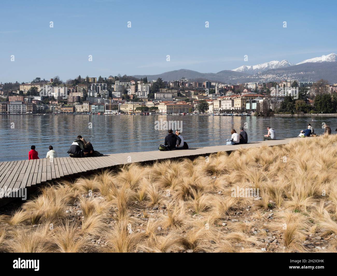 People are relaxing at the lakefront of Lake Lugano at Lugano, Switzerland Stock Photo