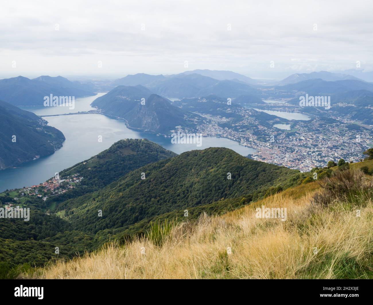 Overlooking the city of Lugano, Lake Lugano, mount San Salvatore and the viaduct of Melide. Stock Photo