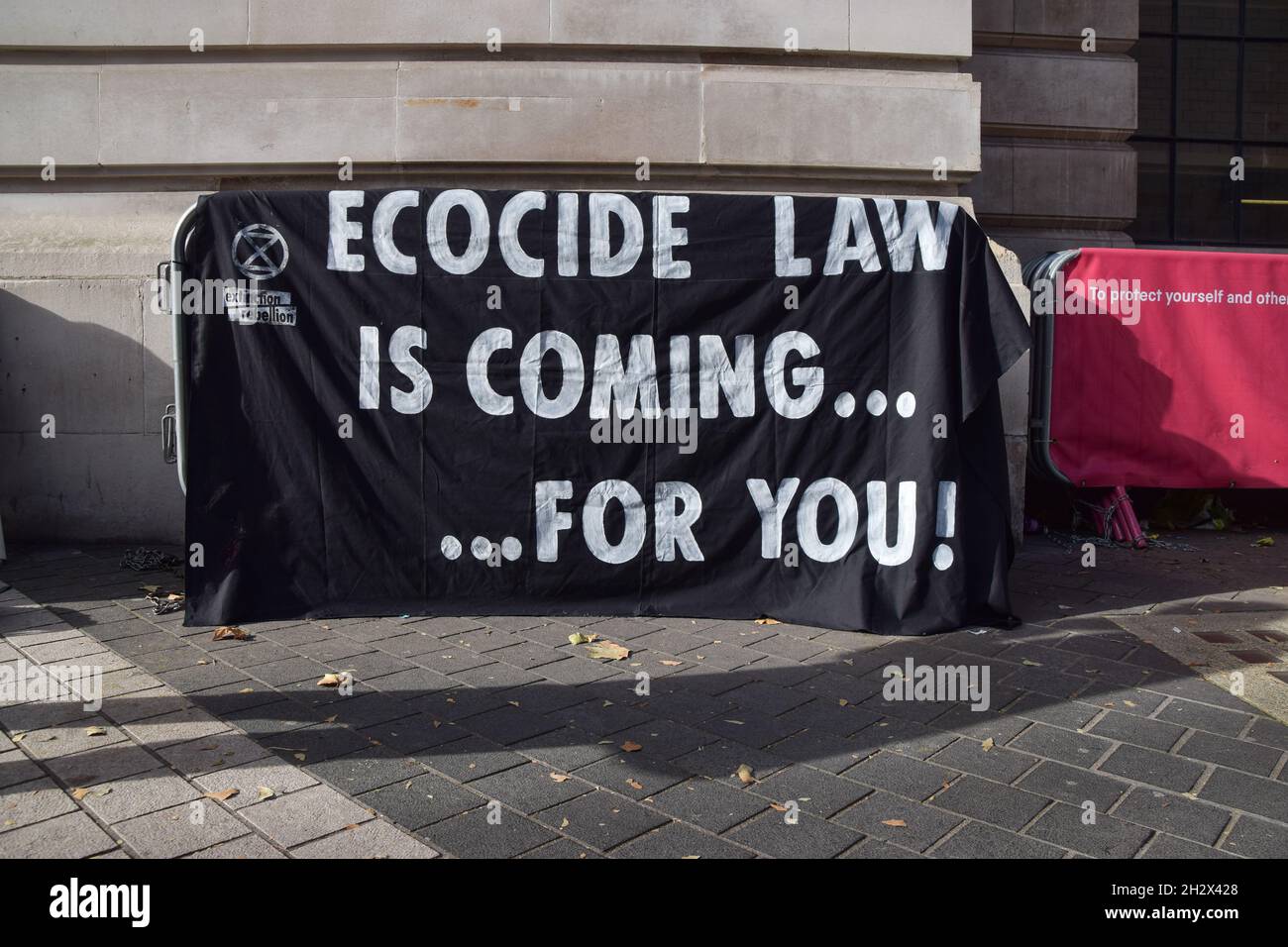 London, UK. 24th Oct, 2021. 'Ecocide Law Is Coming For You' banner is seen during the protest outside the Science Museum. Extinction Rebellion activists gathered outside the museum in South Kensington in protest against the museum's 'greenwash' sponsorship by fossil fuel companies including Shell and coal giants Adani. (Photo by Vuk Valcic/SOPA Images/Sipa USA) Credit: Sipa USA/Alamy Live News Stock Photo