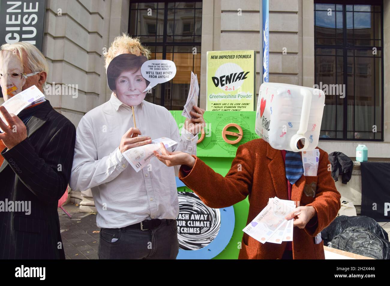 London, UK. 24th Oct, 2021. Activists wearing a mask of Mary Archer, Chair of the Trustees, and a plastic petrol can exchange fake money during the protest outside the Science Museum. Extinction Rebellion activists gathered outside the museum in South Kensington in protest against the museum's 'greenwash' sponsorship by fossil fuel companies including Shell and coal giants Adani. (Photo by Vuk Valcic/SOPA Images/Sipa USA) Credit: Sipa USA/Alamy Live News Stock Photo