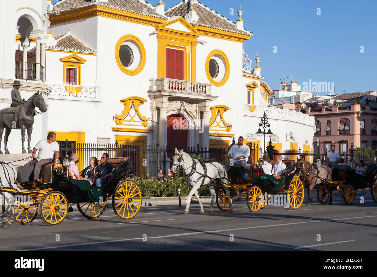 Horsedrawn carriages in front of Plaza de Toros, Seville Stock Photo