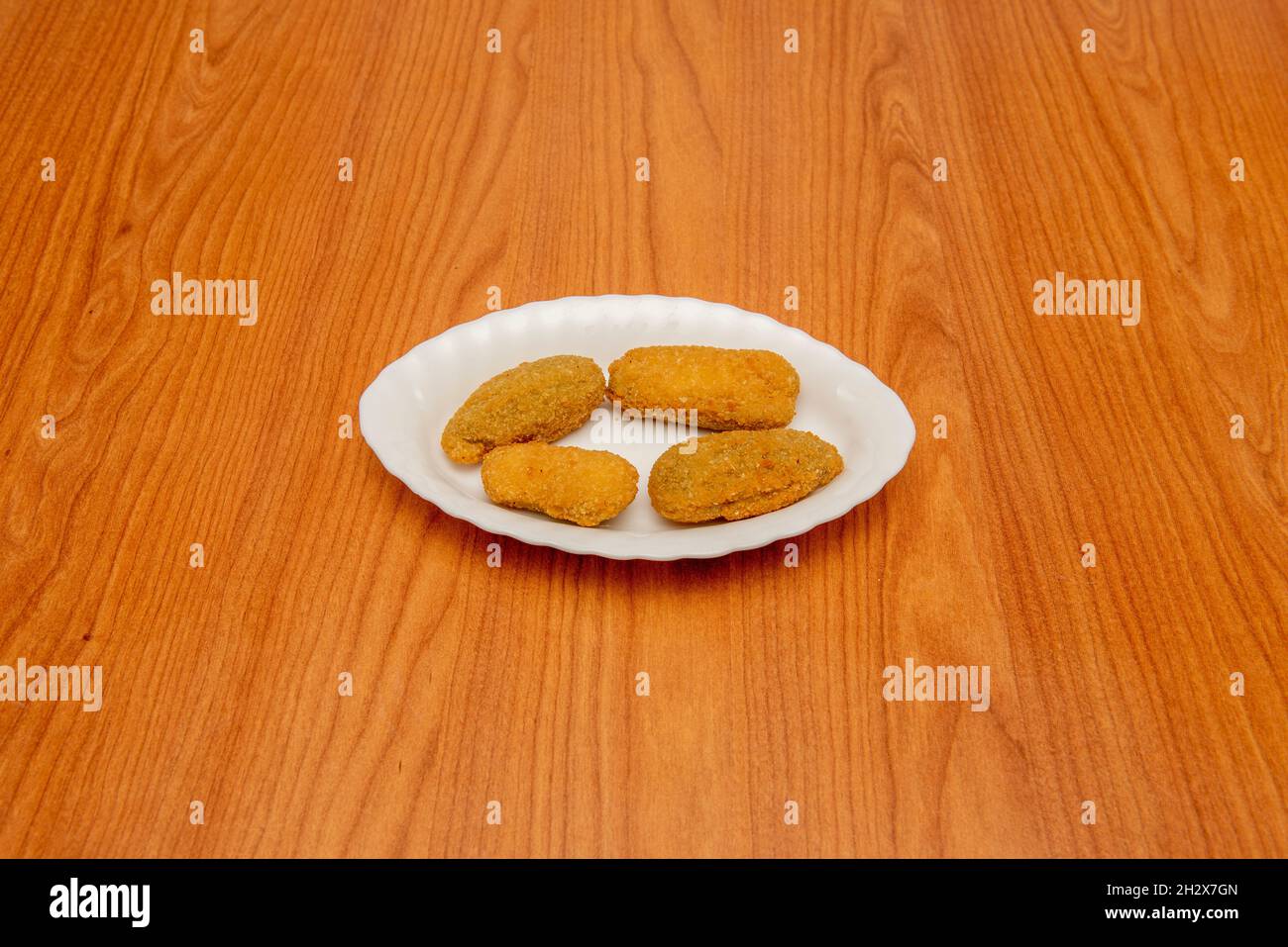 Portion of jalapeno peppers battered in corn flour, egg and breadcrumbs