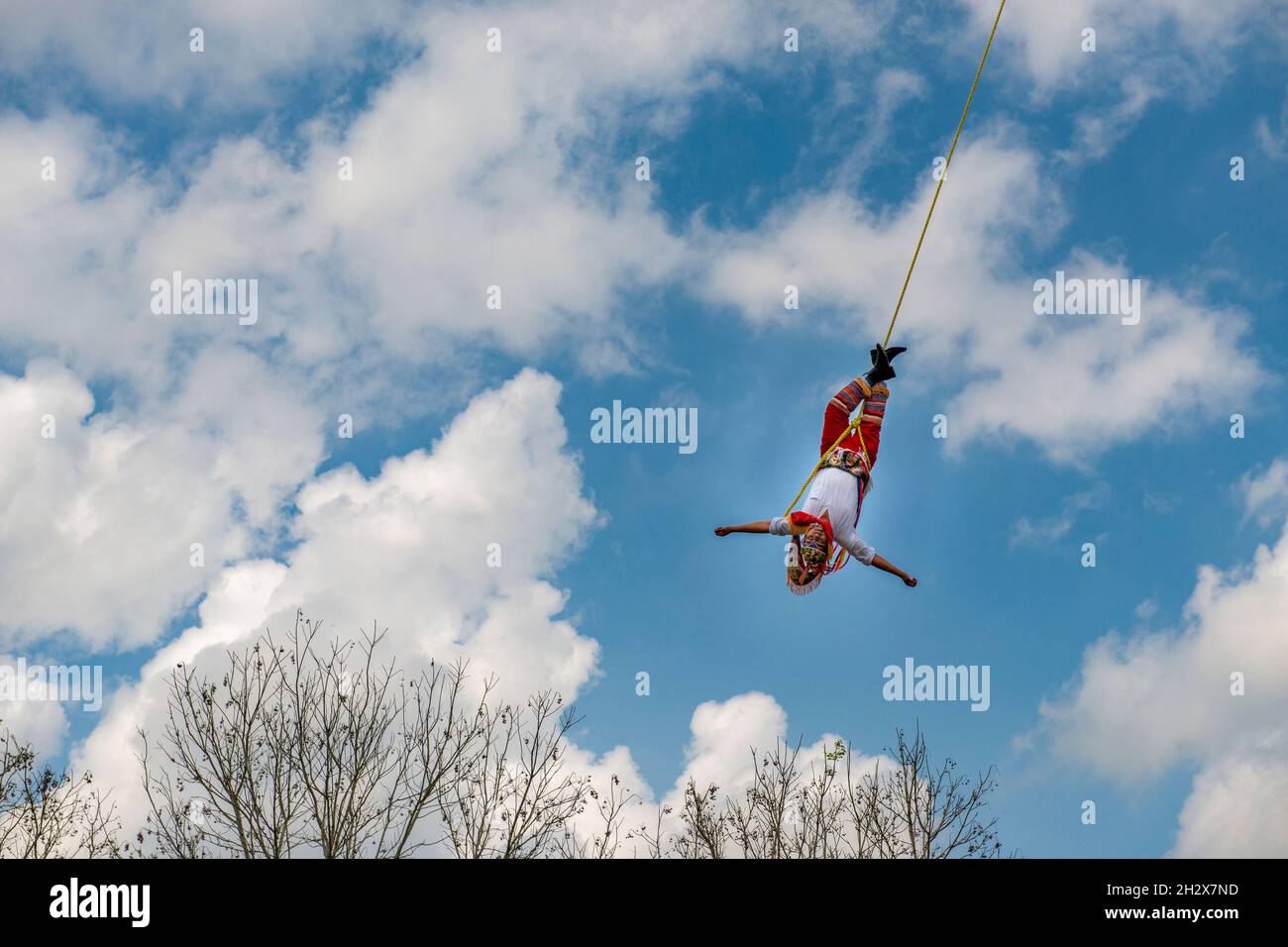 Papantla, Mexico - May 21, 2014: A volador (flying dancer) performing the traditional Danza de los Voladores (Dance of the Flyers) in Papantla, Mexico Stock Photo