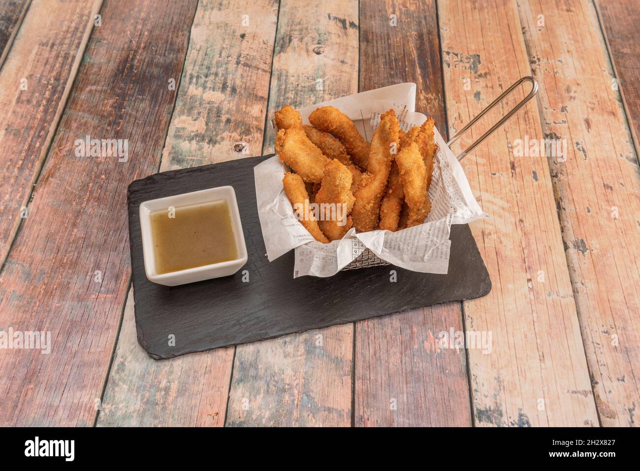 Crispy chicken strips battered in wheat flour and breadcrumbs fried in