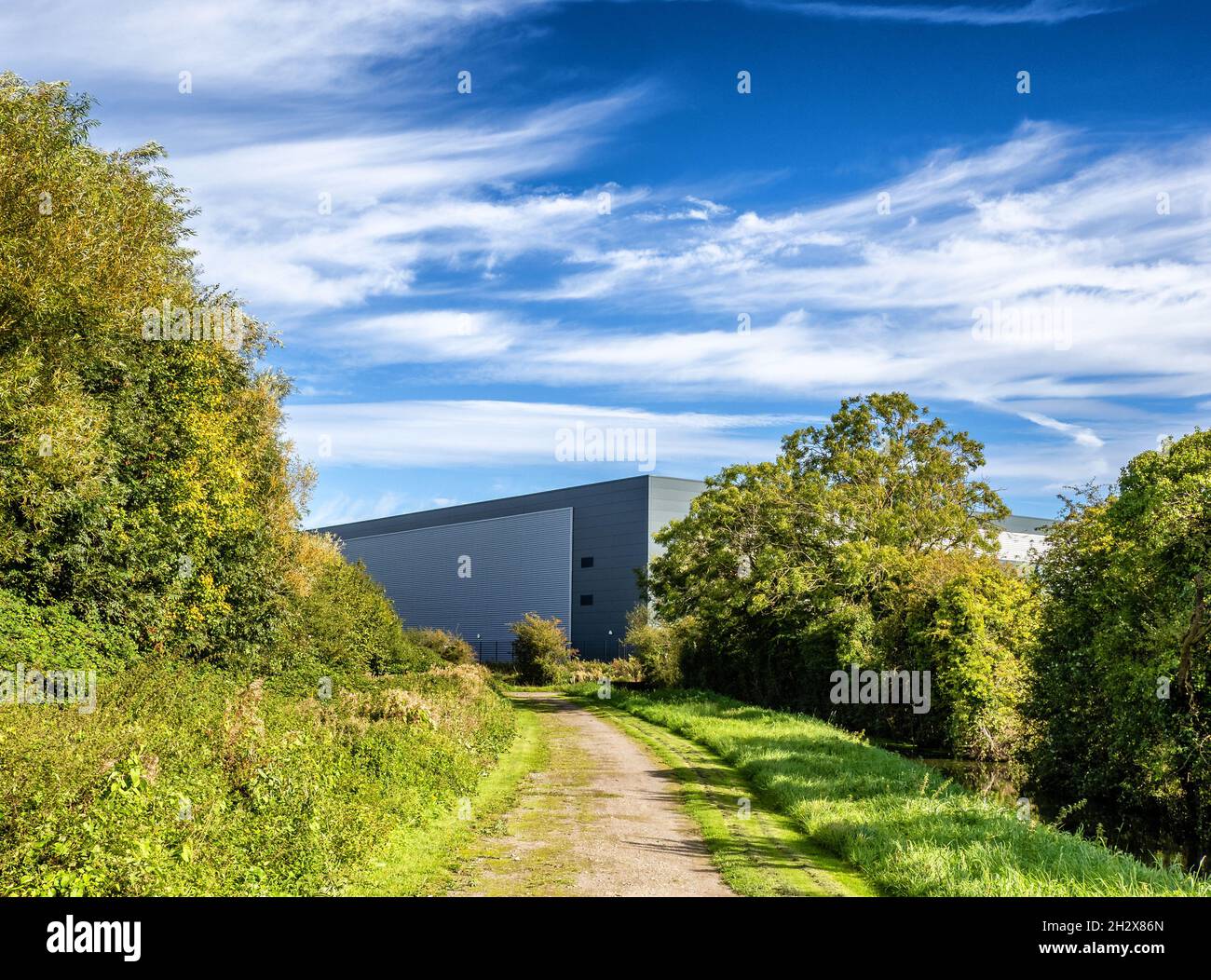 Giant warehouse at the end of a green lane on a newly developed