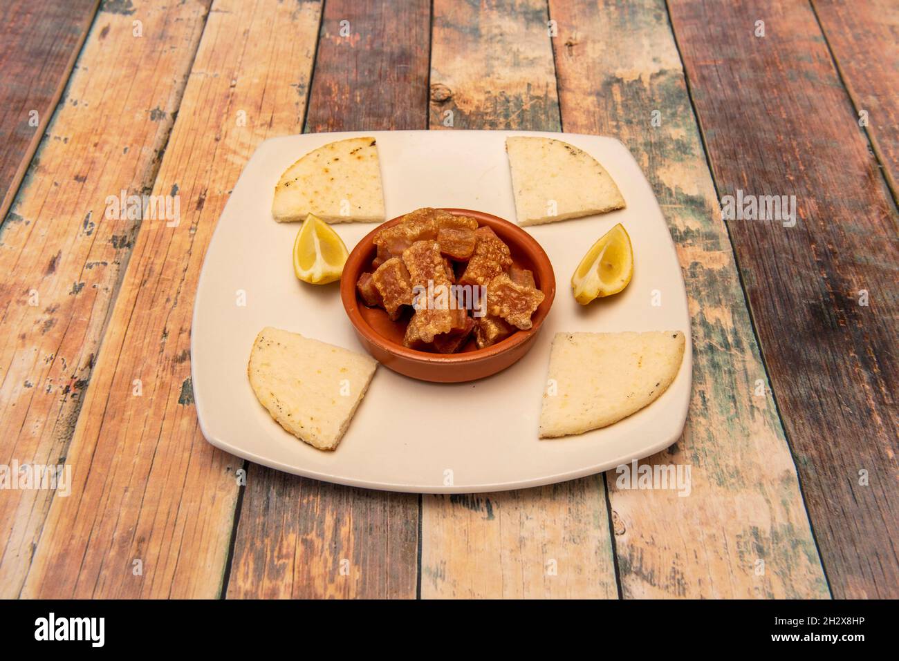Latin American fried pork rinds with lemon for dressing and