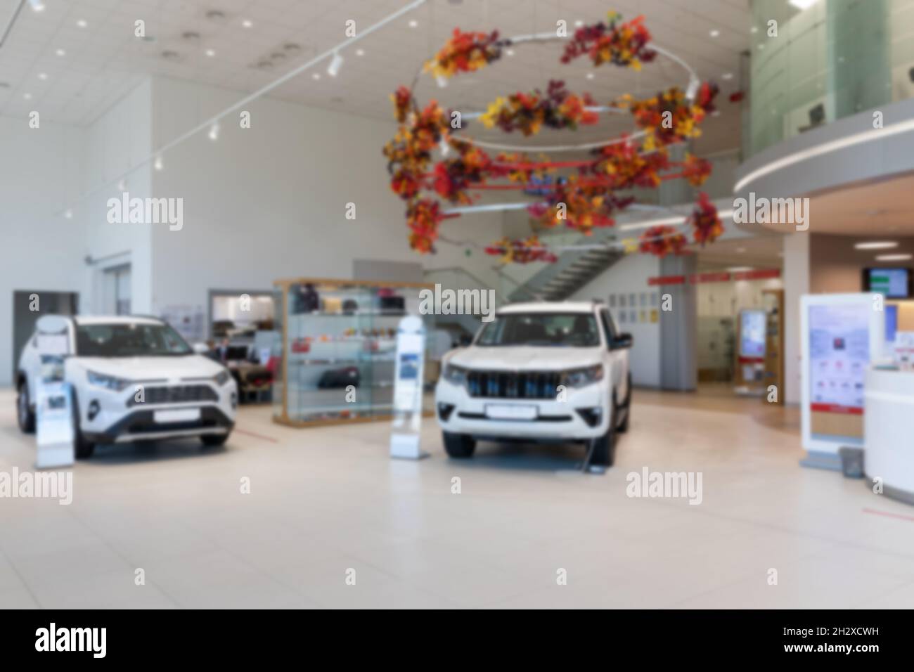 interior of a modern car dealership with white SUVs, premium showroom
