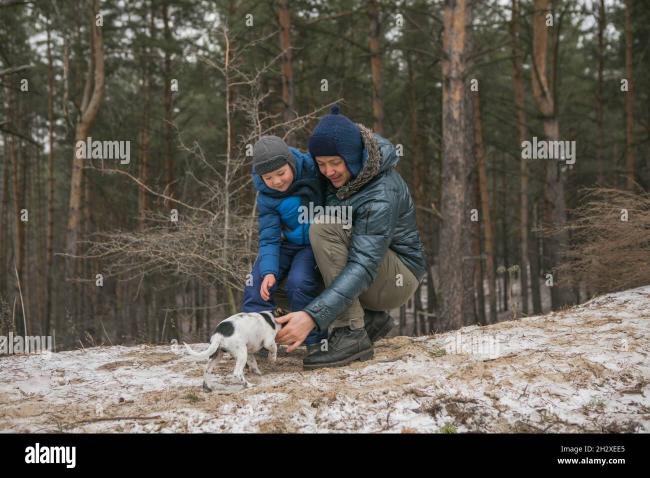 Happy family on a walk outdoors in sunny winter forest, Christmas ...