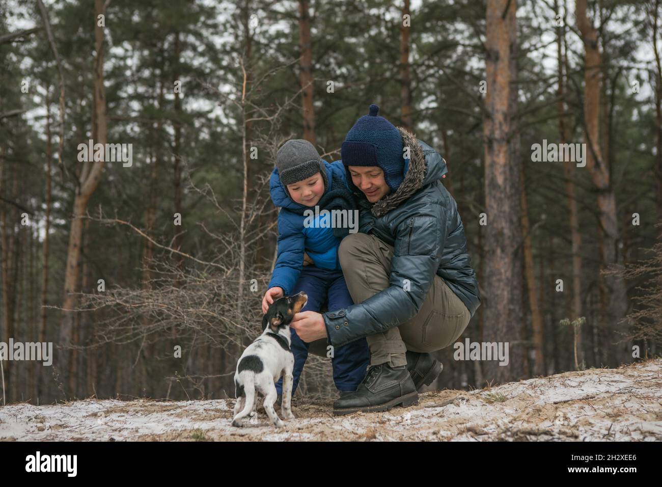 Happy family on a walk outdoors in sunny winter forest, Christmas ...