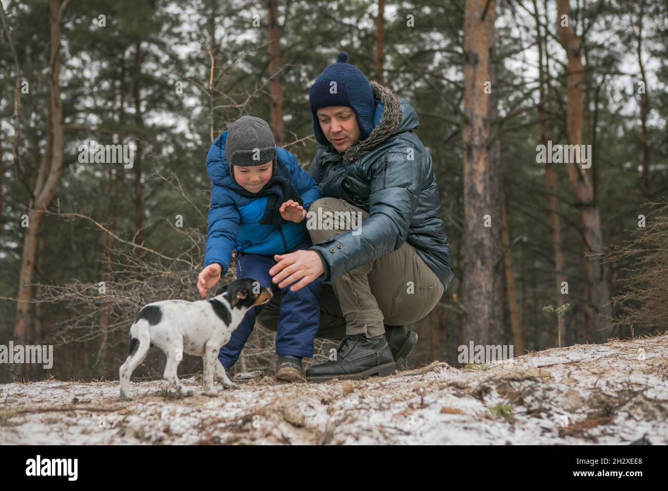 Happy family on a walk outdoors in sunny winter forest, Christmas ...