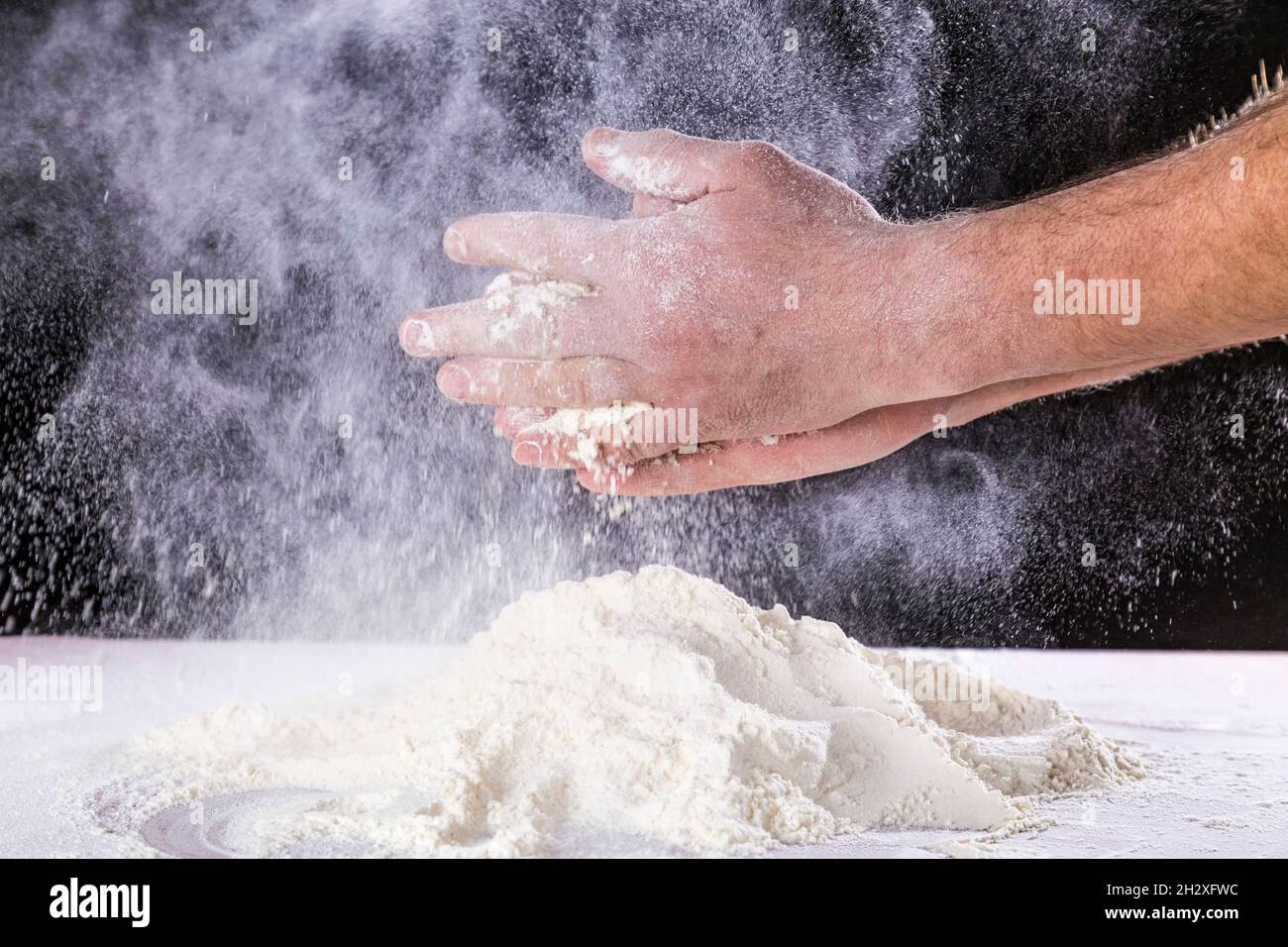 Close up of chef human's hands preparing for kneading the dough on the ...