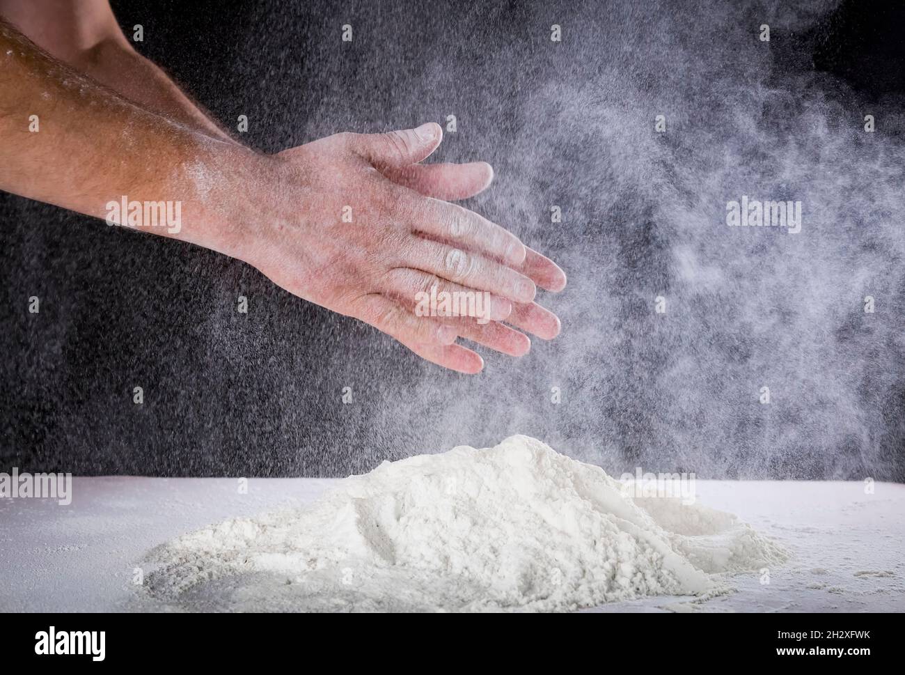 Close up of chef human's hands preparing for kneading the dough on the ...