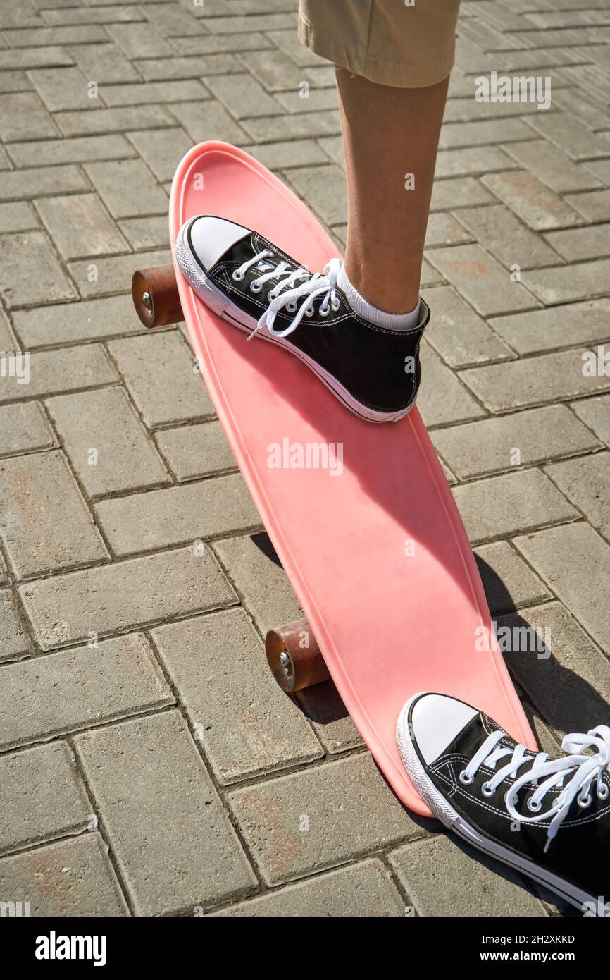 Girl with skateboard. Town landscape. Black sneakers. New normal travel  Stock Photo - Alamy