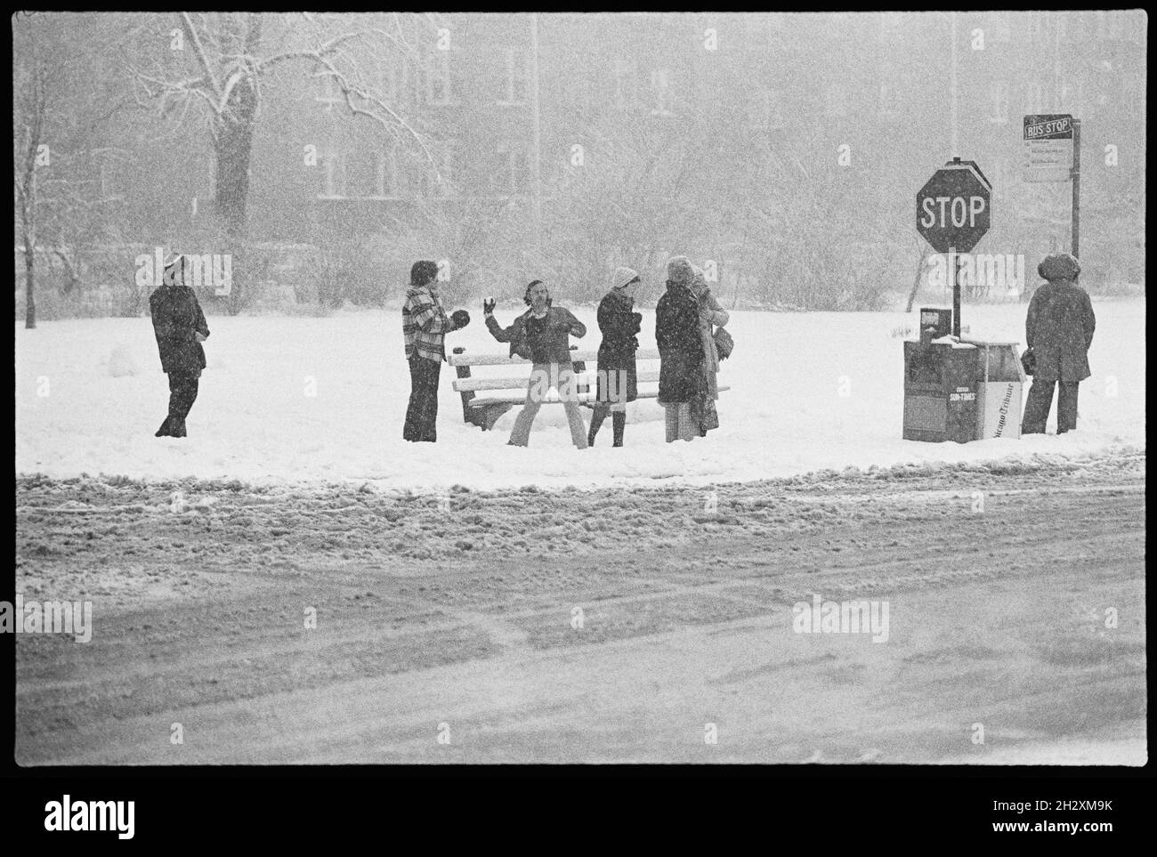 Troublemaker throws a snowball at a bus stop in Chicago, 1976. Stock Photo