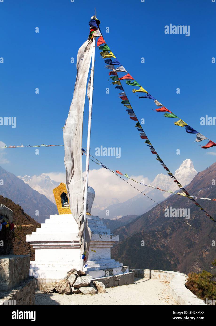 White stupa and prayer flags near Namche Bazar, mount Everest, Lhotse and Ama Dablam, way to Everest base camp, Khumbu valley, Solukhumbu, Sagarmatha Stock Photo