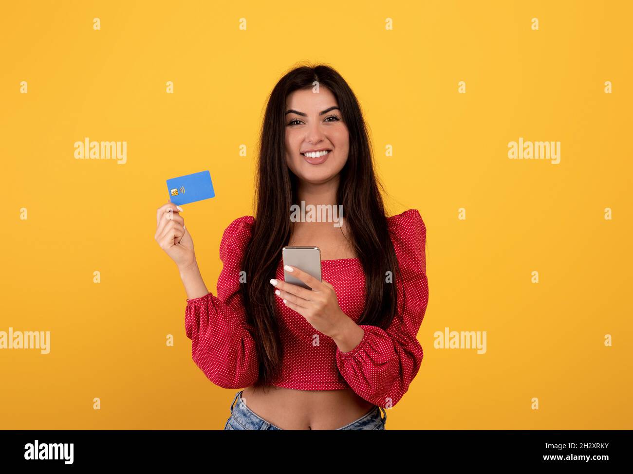 Easy money transfer. Cheerful armenian lady showing credit card and
