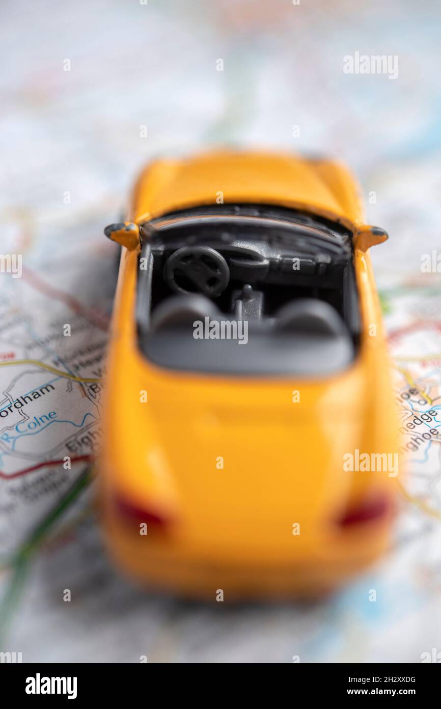 Toy car on a road map Stock Photo - Alamy