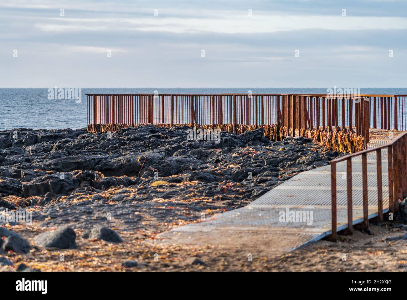 Rusty viewpoint to the ocean over the lava fields Stock Photo