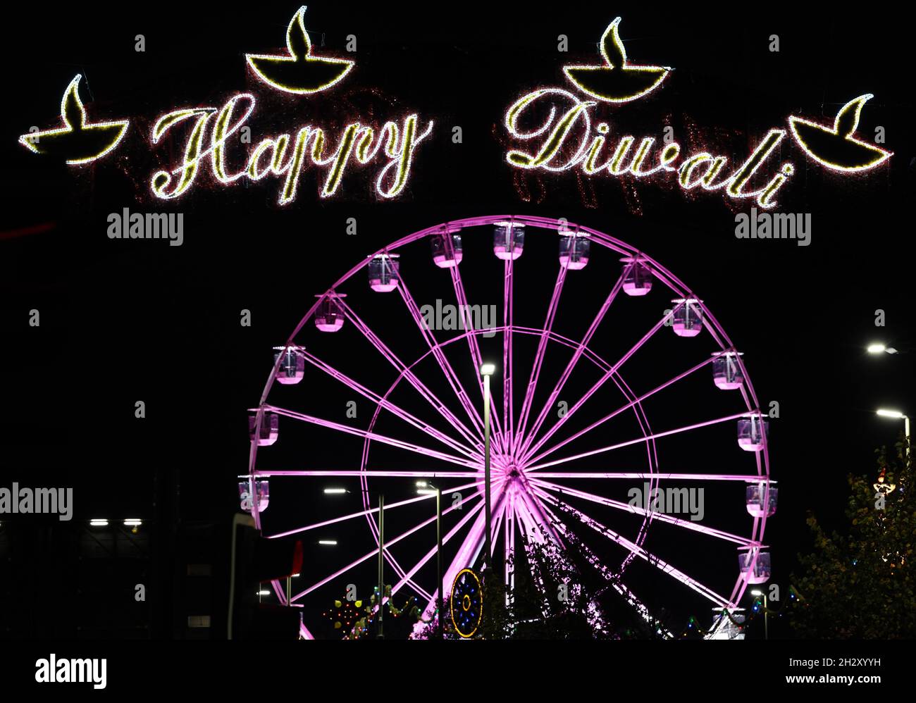 Leicester, Leicestershire, UK. 24th October 2021. A ferris wheel stands over Diwali lights on the Golden Mile after a switch on event different from normal with no main stage or firework display because of Covid-19 worries. Credit Darren Staples/Alamy Live News. Stock Photo