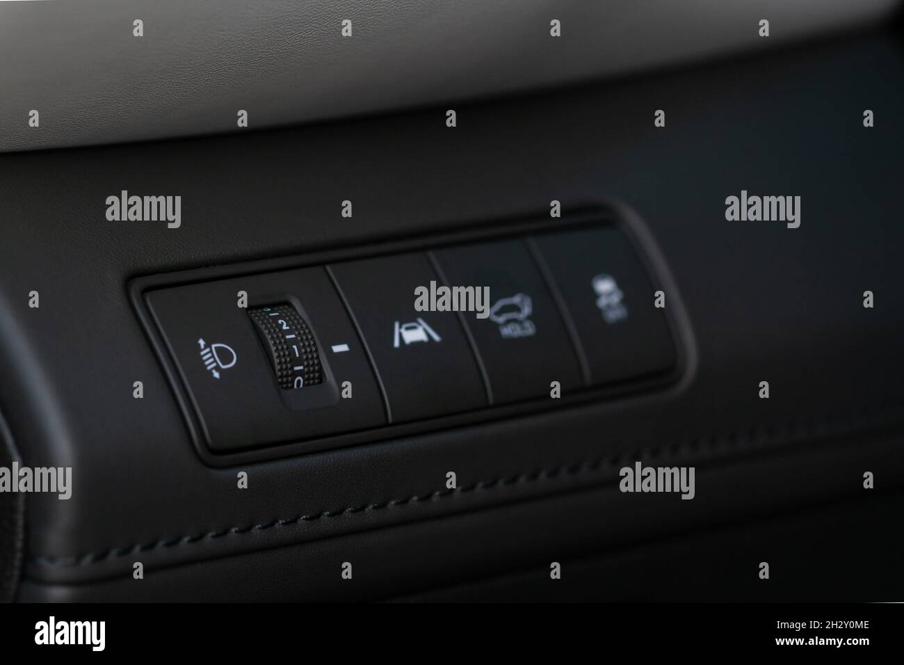 Headlights corrector adjustment buttons. lose up view of the modern car