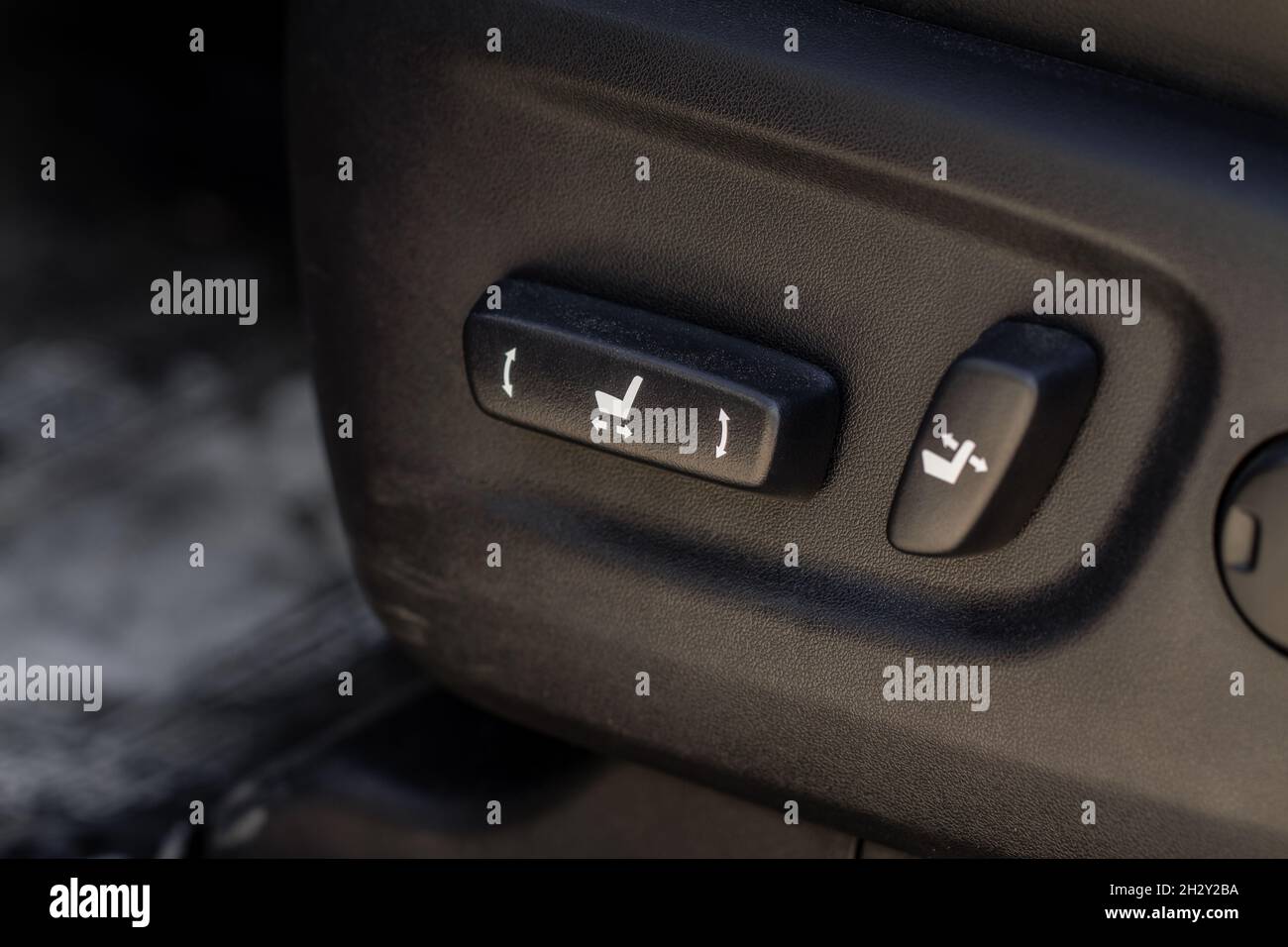 Electric car seat adjustment control panel close up view. Adjustable