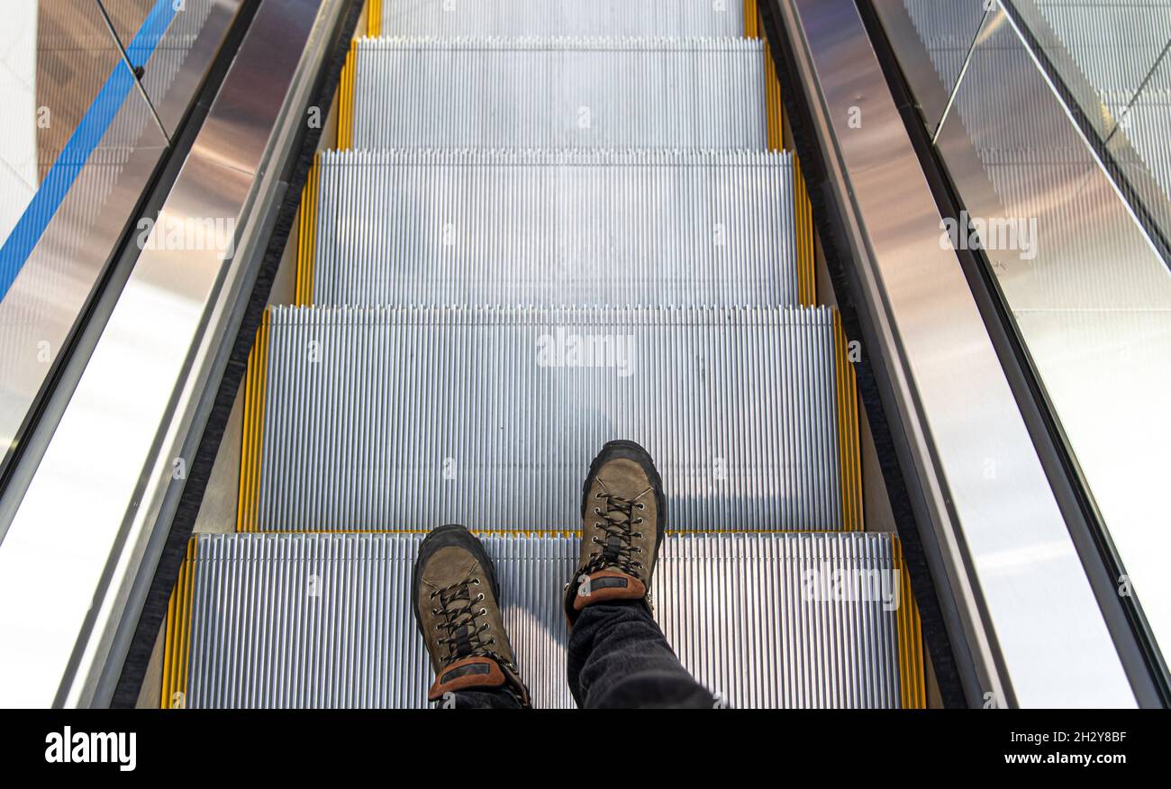 Male feet on the escalator, top view Stock Photo - Alamy