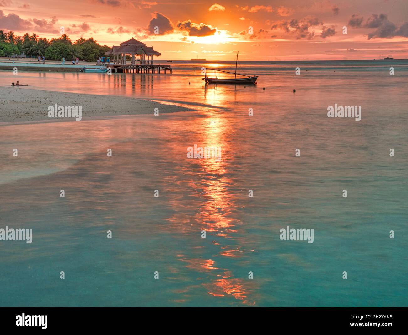 A boat sailing in the sea at sunset Stock Photo - Alamy
