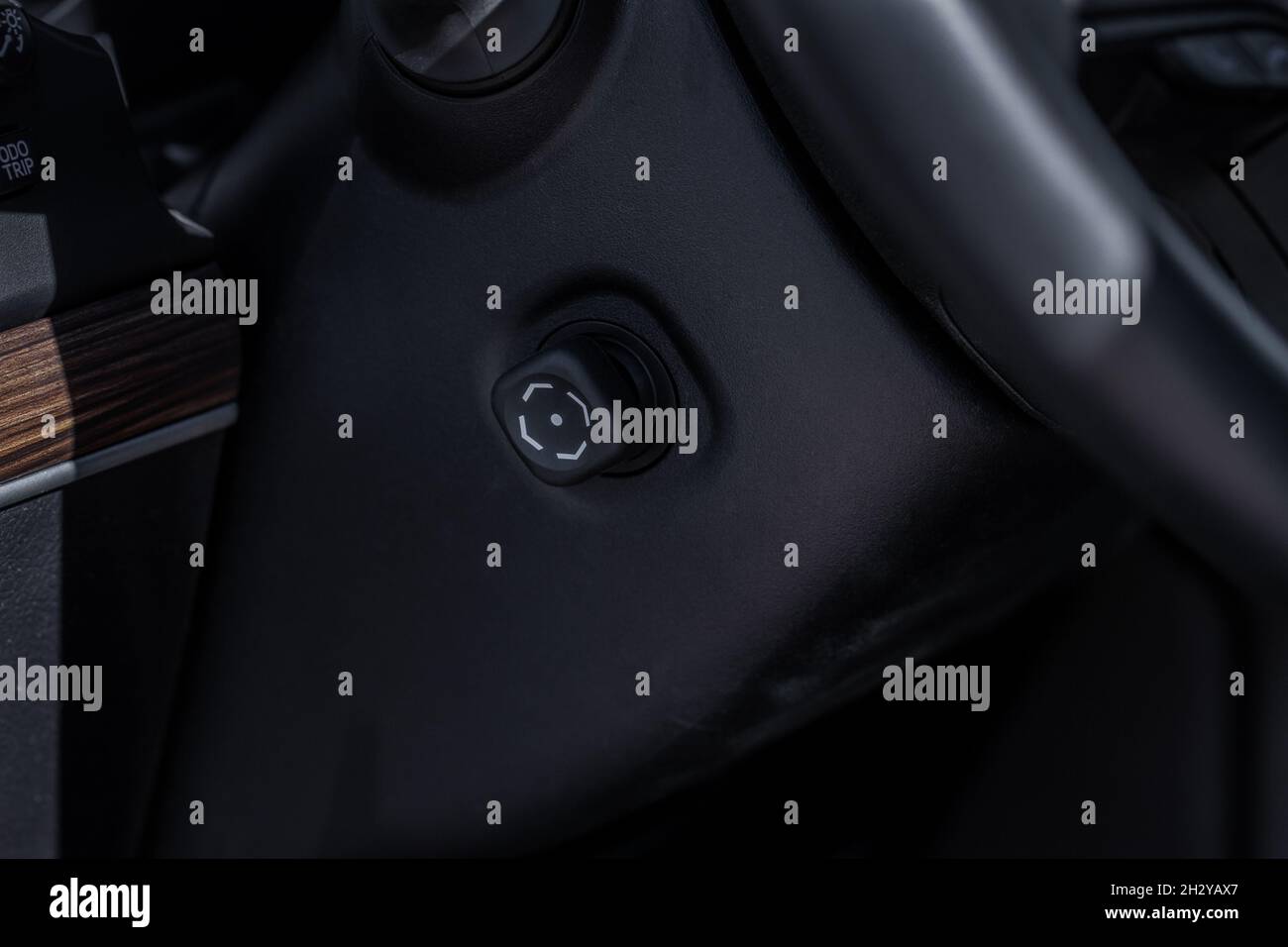 Adjustable steering wheel in modern car. Tilt and telescopic steering control lever. Steering