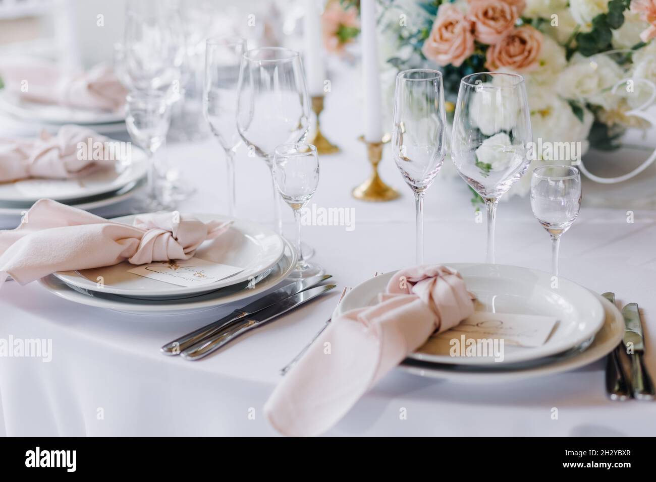 Decorating the wedding table with flowers and beautiful table setting Stock Photo
