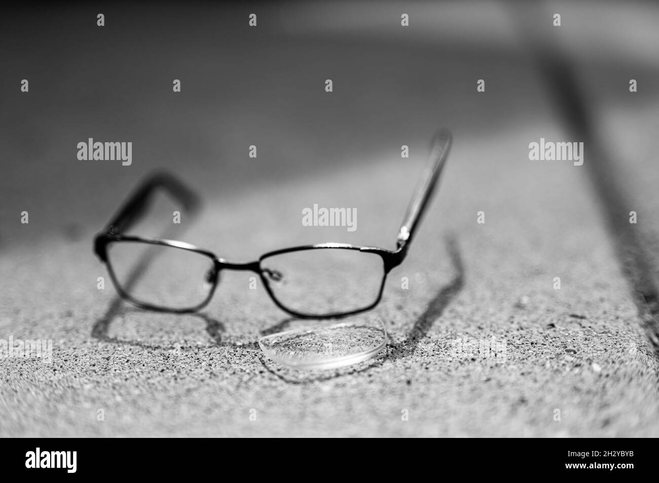 Selective focus on damaged glasses with scratched lens popped out Stock