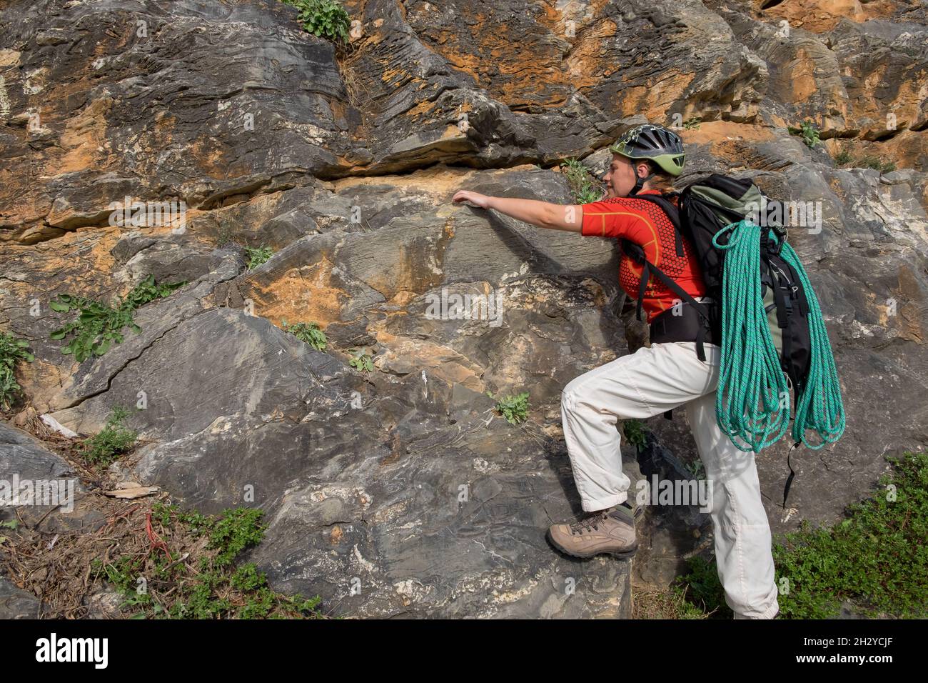 Female rock climber with climbing equipment Stock Photo