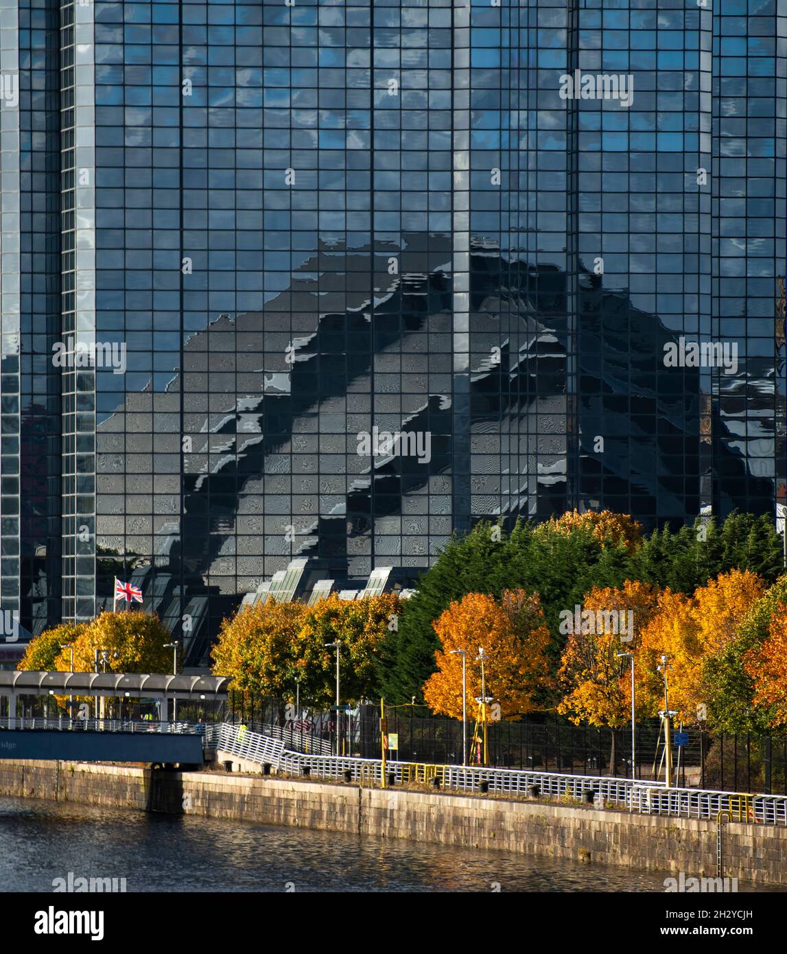 Glasgow, Scotland, UK. 24 October 2021 PICTURED: Glasgow Crown Plaza hotel reflecting the image of the SEC Armadilo building in its exterior mirrored windows. Views of the COP26 site showing the river Clyde and dockside, with the Scottish Event Campus buildings (OVO Hydro Arena, SEC Armadillo and SECC buildings) along with the Crown Plaza Hotel and the ring of steel security fence surrounding the area. Days until Heads of State, along with thousands of delegates and media and protestors are expected to land in Glasgow very shortly for the beginning of the Climate Change Summit starting on 31 O Stock Photo