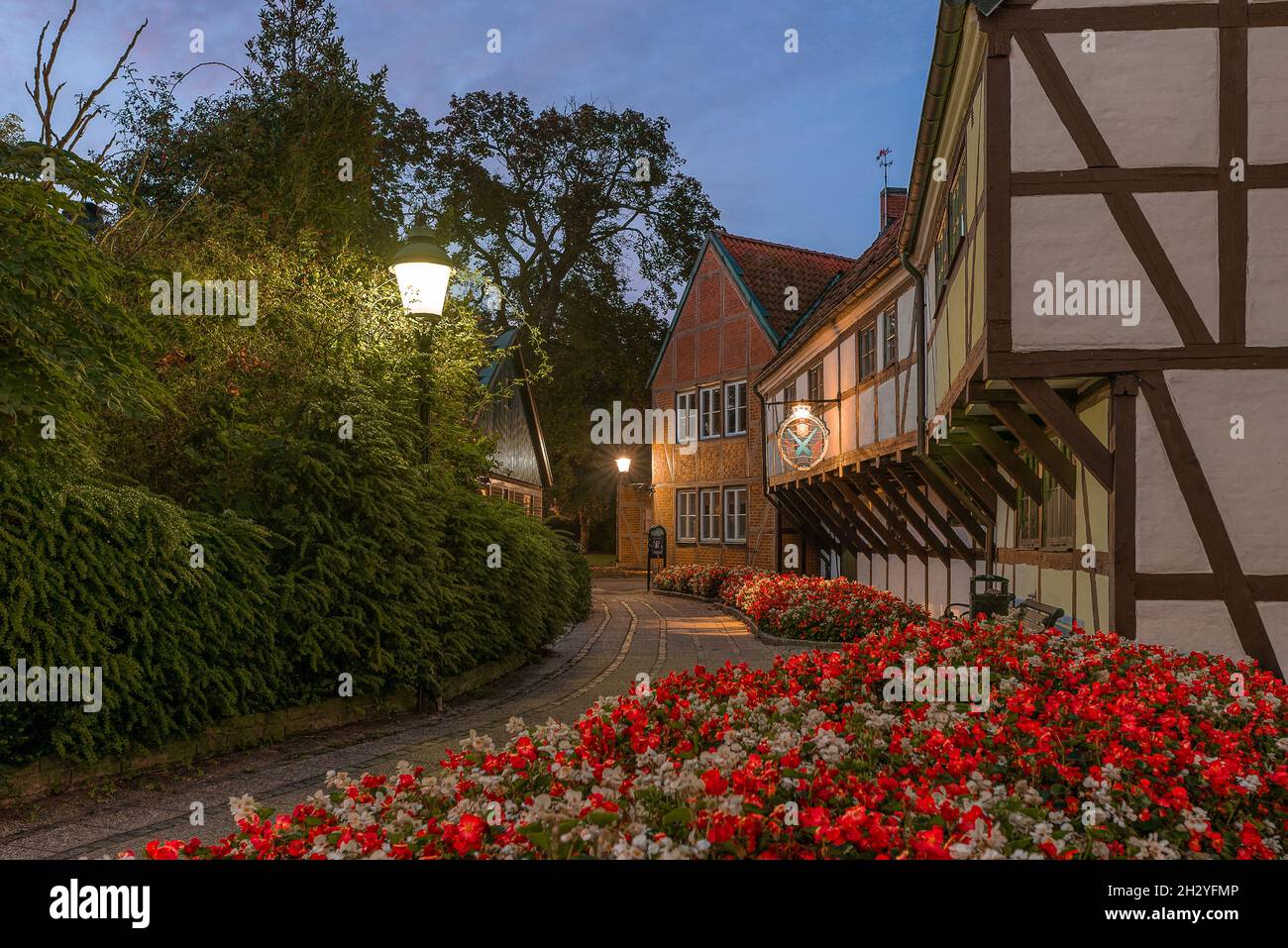 half-timbered houses and a flowerbed of red flowers at Ystads frivillige bergnings corpus, Ystad, Sweden, September 14, 2021 Stock Photo
