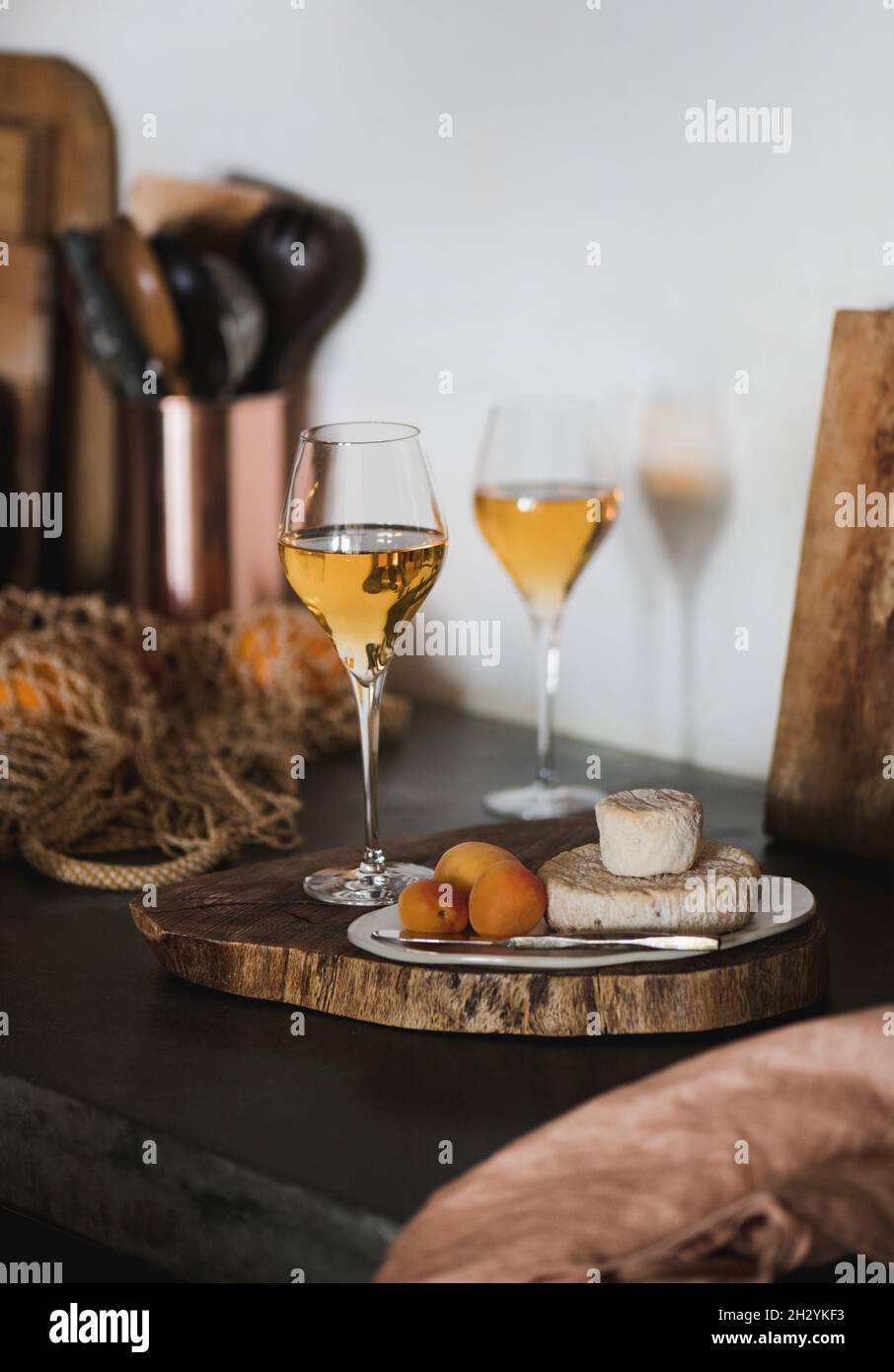 Orange or Amber wine in wineglass and appetizers snacks Stock Photo