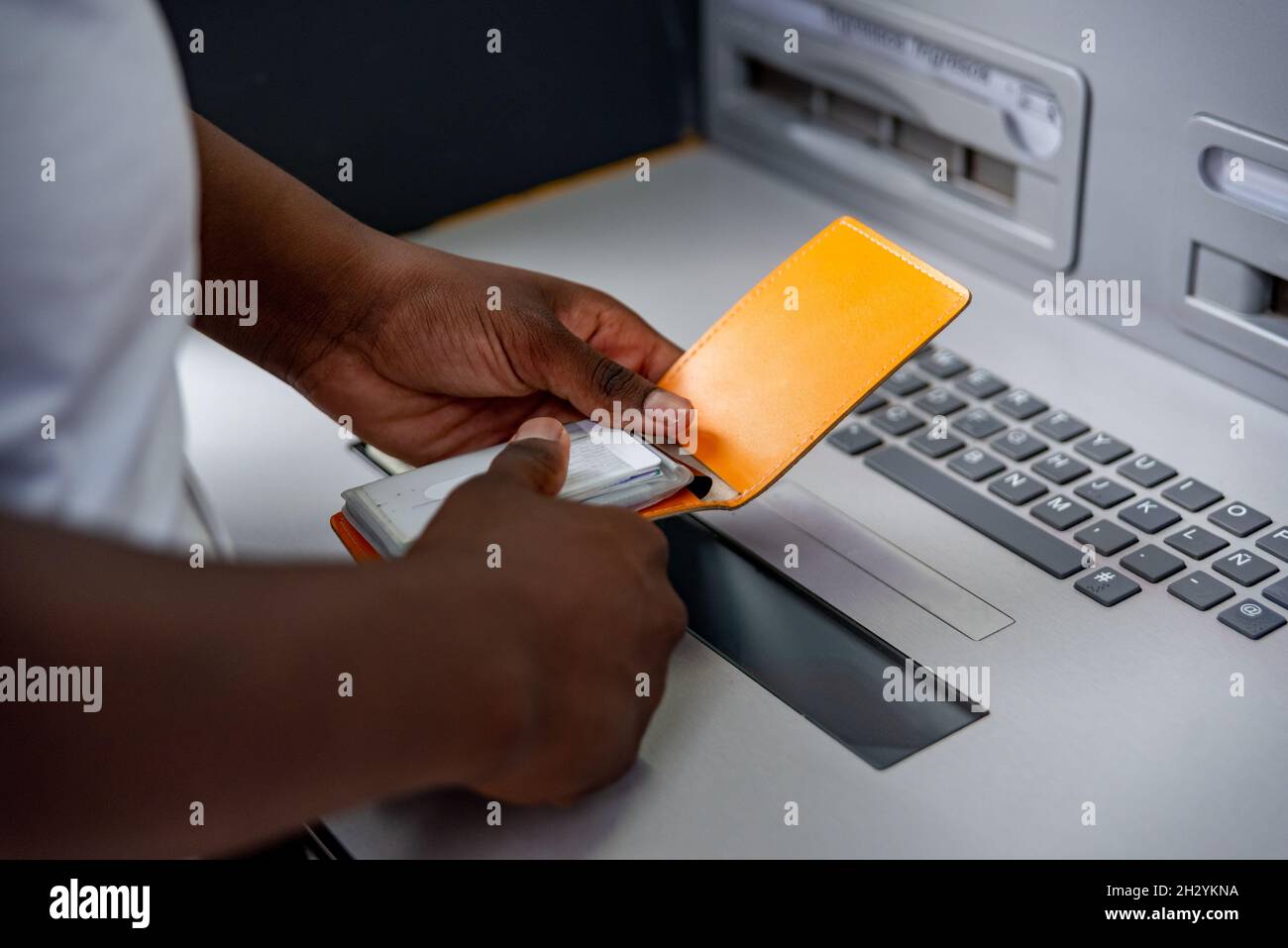 Afro young man in ATM. Close up Stock Photo