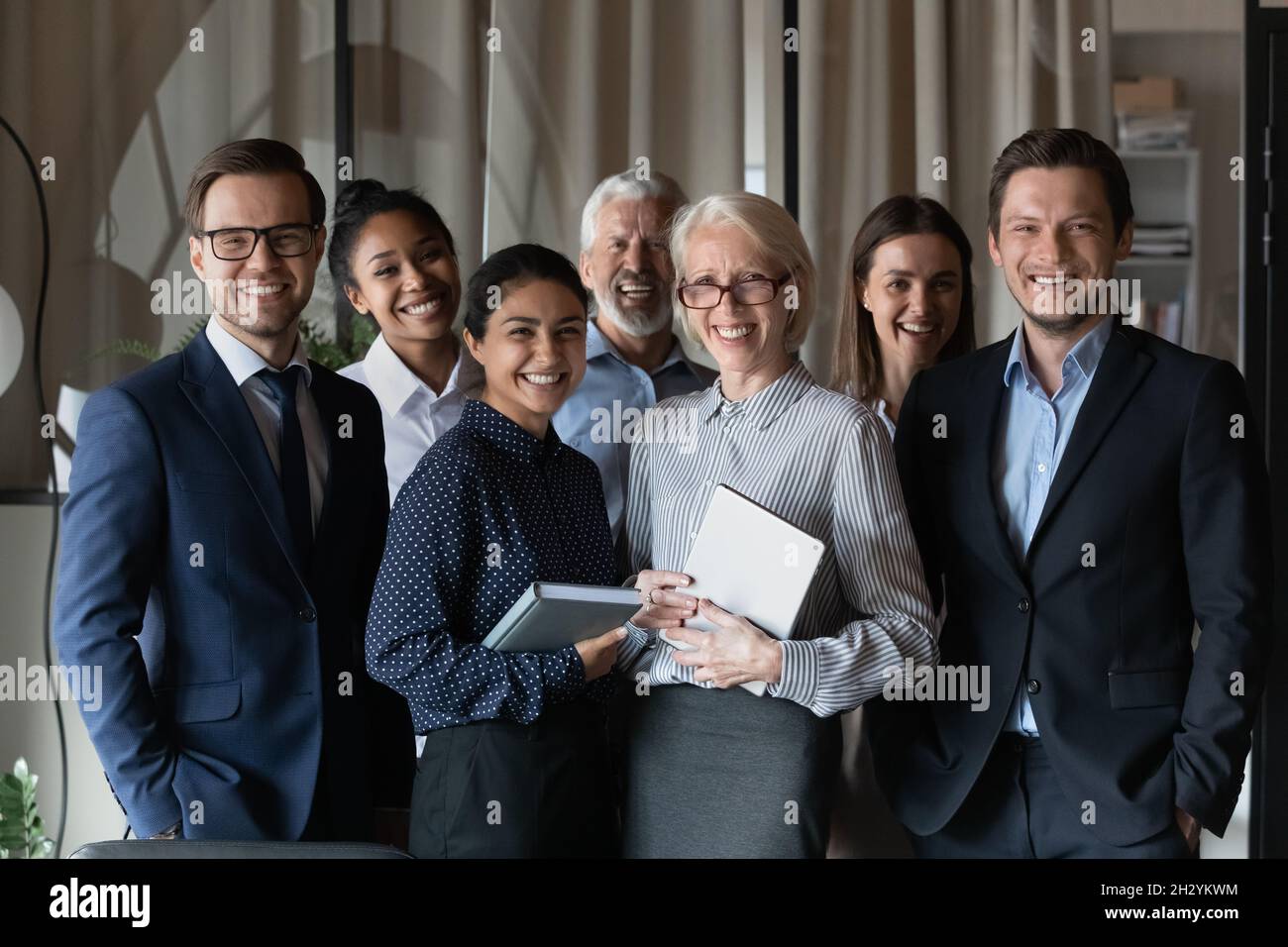 Old and young age multiethnic corporate staff look at camera Stock Photo