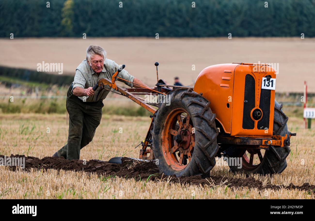 Man with hand plough ploughing furrow at 70th British Ploughing