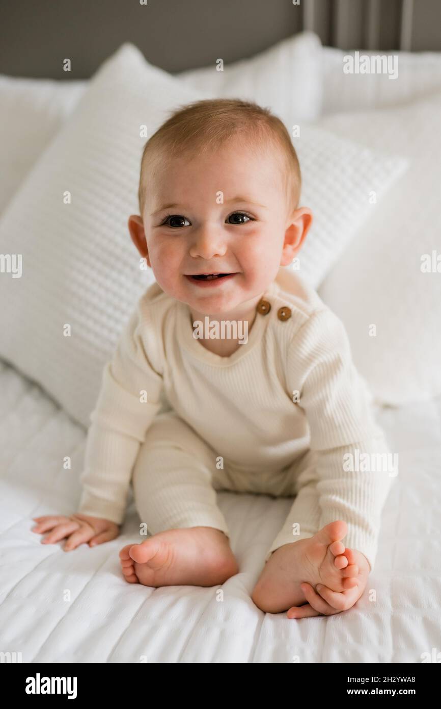 Curious baby boy sitting on bed hi-res stock photography and images - Alamy