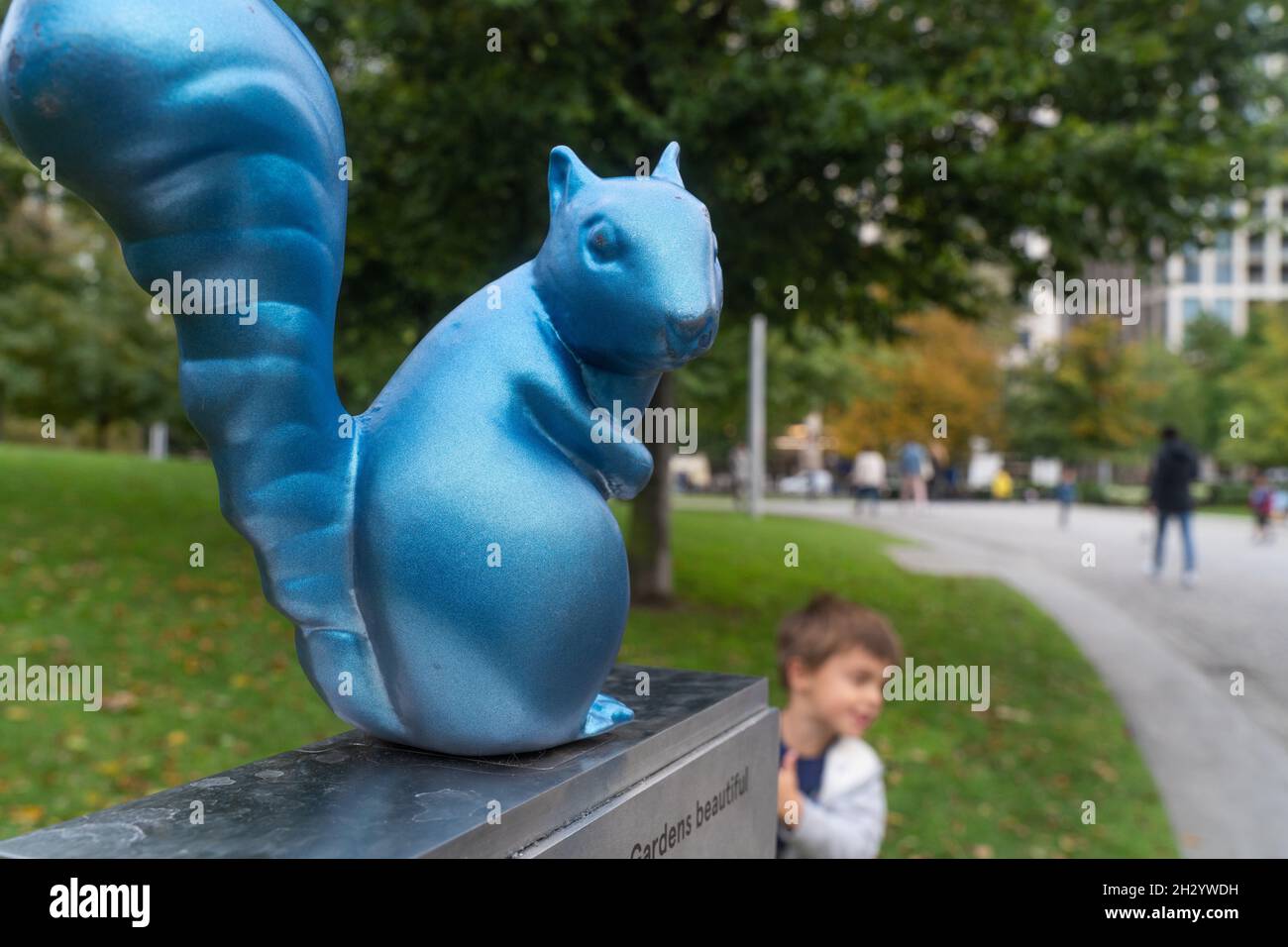 Blue squirrel sculpture sitting on contactless donation point in Jubilee Gardens, South bank, London, England Stock Photo