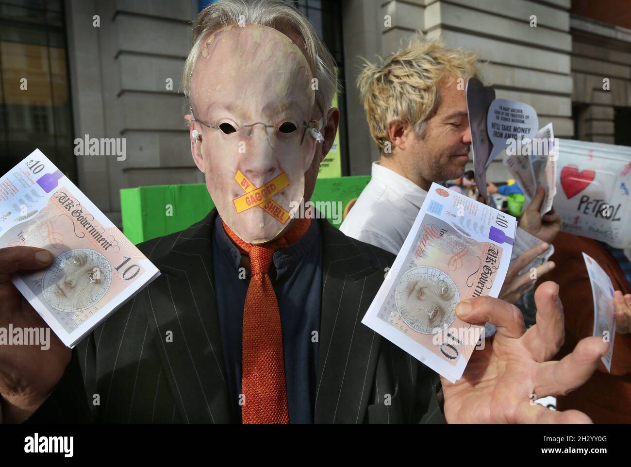 London, UK. 24th Oct, 2021. A protester in a gagged by Shell mask and cash, suggesting money invested stops the science museum asking awkward ethical questions . Extinction Rebellion protesters insist that the Science Museum stop receiving sponsorship from multinational oil and gas companies like Shell and BP. By accepting sponsorship from some of the world's biggest polluters prestigious museums are helping them clean up their image and continue their devastating planetary destruction. Credit: SOPA Images Limited/Alamy Live News Stock Photo