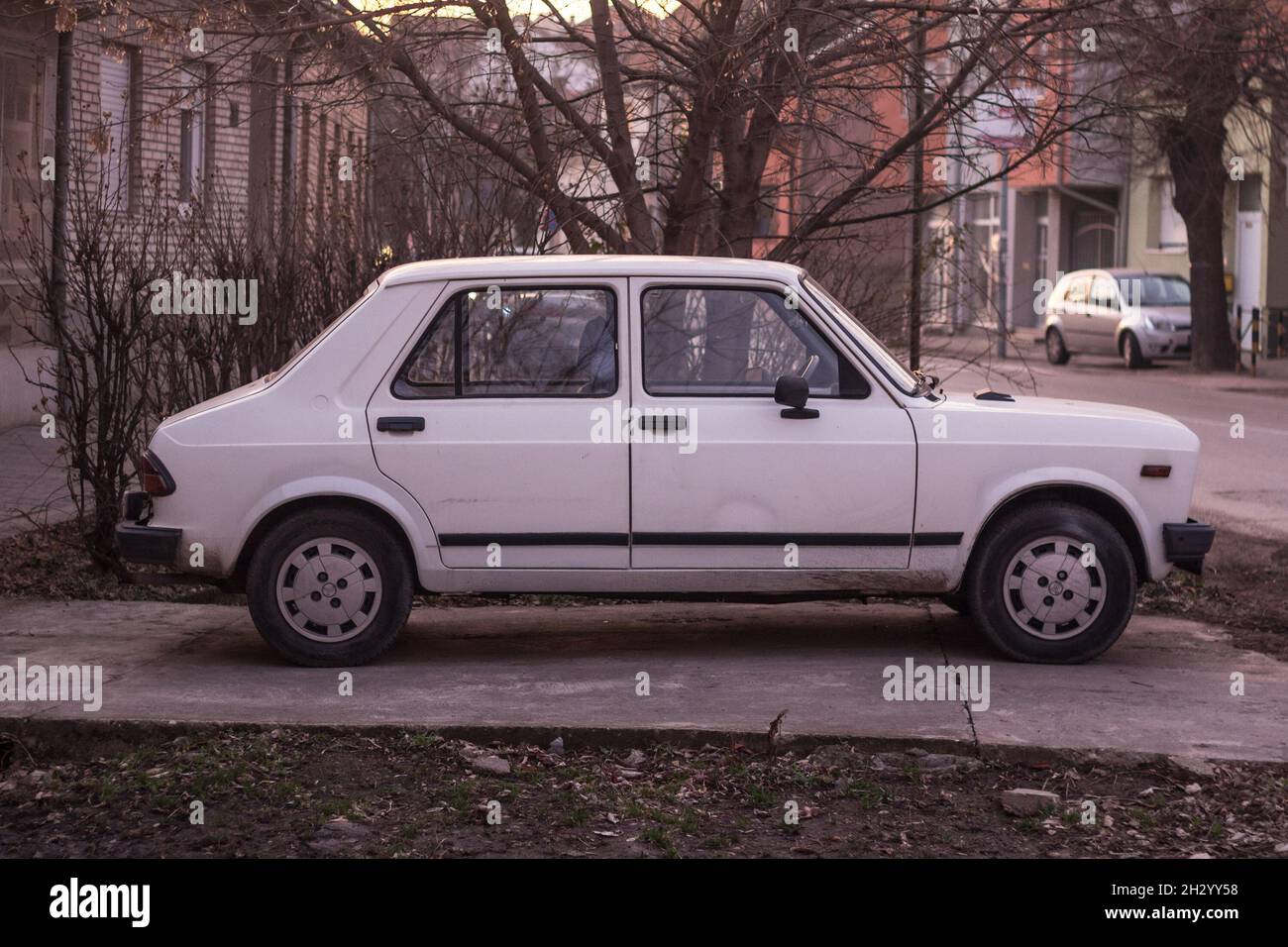 Picture of a Skala car, white colors, branded as Zastava 55 and Yugo 55, parked in a car park of Vrsac Serbia. Skala is a generic name for a family of Stock Photo