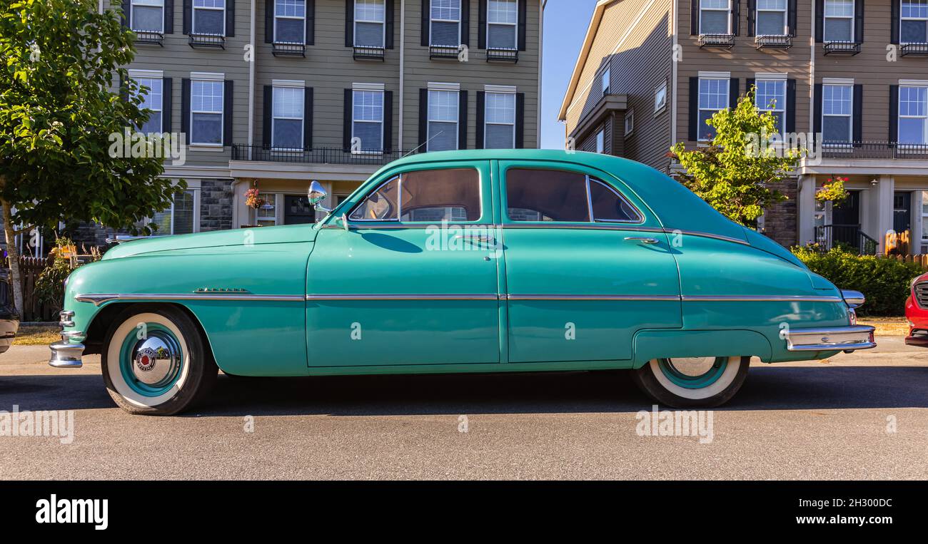A classic Packard parked on the street. A vinage car Packard 1949 on a street turquoise color. Stock Photo