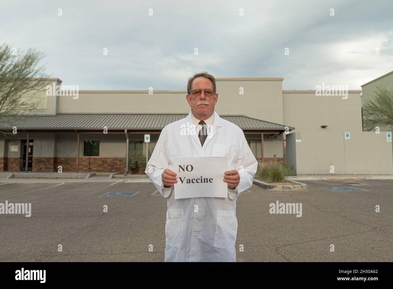 Physician activist holds sign in protest against covid vaccine mandate Stock Photo