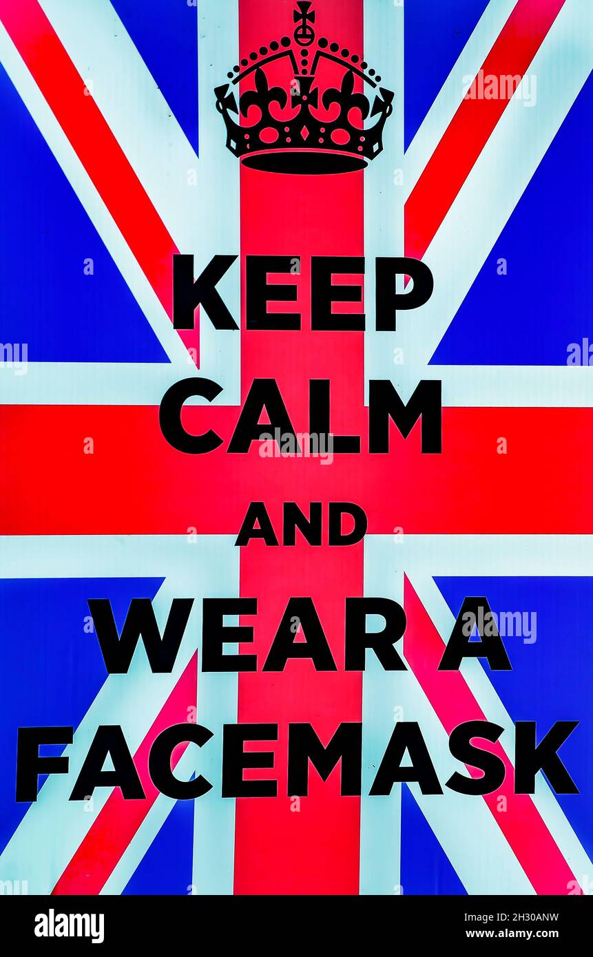 A sign reminds people to “Keep calm and wear a facemask” at the 31st annual British Car Festival, Oct. 24, 2021, in Fairhope, Alabama. Stock Photo