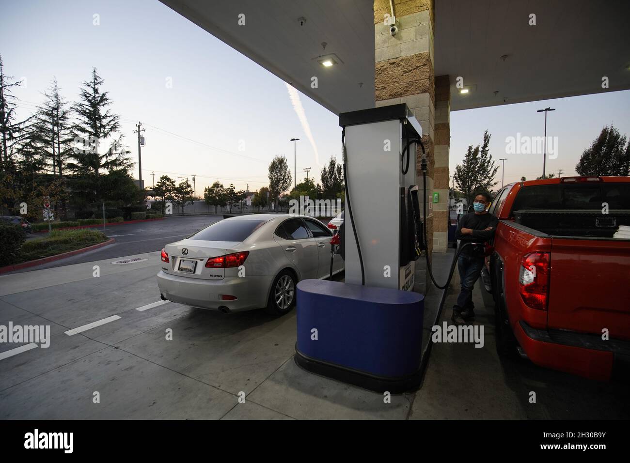 Drivers pump gas at a gas station of Costco in California.In the United