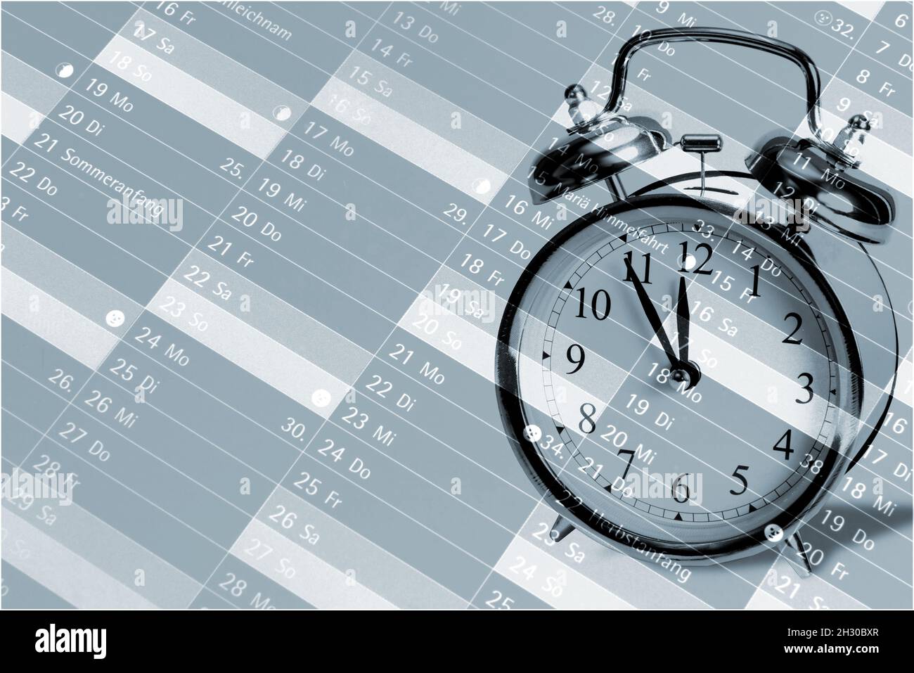 An alarm clock and a calendar Stock Photo