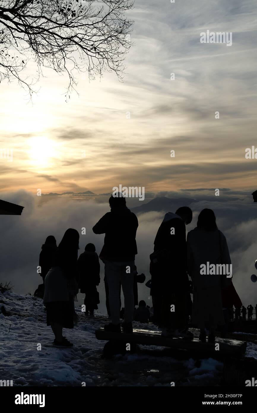 Nagano, Japan, 2021-24-10 , Silouette of Tourists waiting for the sunset at the Ryuoo Sora Terrace, a utopia-like viewpoint 1,770 meters above sea lev Stock Photo