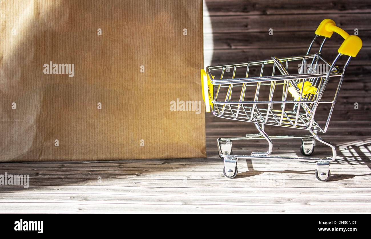 Supermarket, shopping basket and paper bag in the store Stock Photo